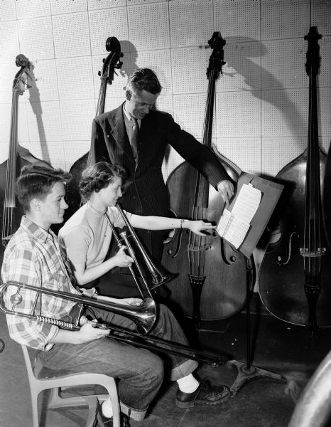 Central High School band director W.J. Fandrich instructs two student trombone players, Eugene Nelson (left) and Beatrice Newton.