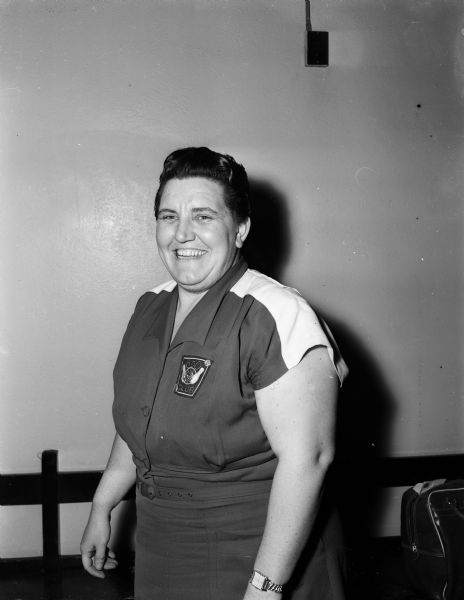 Portrait of Kelly Butterworth, a grade school teacher and athletic coach at Fall River, who rolled a 608 series in the double competition of the Madison Woman's Bowling Association to win the doubles title with her partner, Dorothy Griffiths.