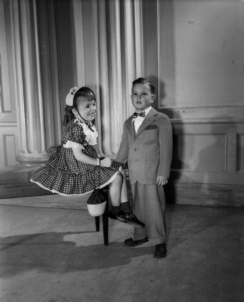 Kim Mary Reese, age 5, daughter of Mr. and Mrs John Reese of 4255 Beverly Road, modeling a dress for the Jaycettes' style show. On the right is Richard Davis, age 4, son of Mr. and Mrs. Allen Davis of 121 S. Hancock Street, modeling a suit for the show.  "Under the Big Top" is the theme of this year's production sponsored by the Junior Chamber of Commerce Auxiliary (Jaycettes).