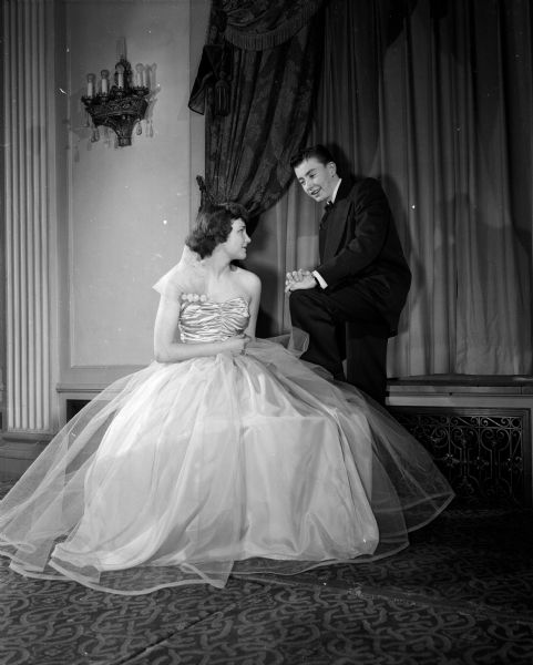Diane Giswold, daughter of Dr. and Mrs. L. G. Giswold of 821 South Shore Drive, models a formal gown while Frank Q. Doyle III, son of Mr. and Mrs. Frank Q. Doyle, Jr. of 16 Sherman Terrace, models a suit for the annual Jaycettes style show held at the Crystal Ballroom in the Hotel Loraine, 123 West Washington Avenue.
