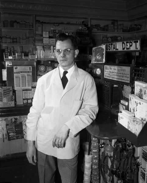 Portrait of "Bud" Shafer, owner of Shafer's Pharmacy at 1351 Williamson Street.  Shafer is a graduate of University of Wisconsin School of Pharmacy.