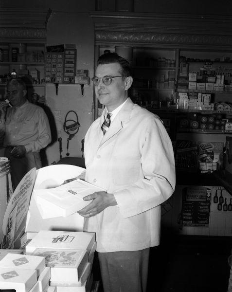 Portrait of Walter A. Schultz, druggist at Lucky Pharmacy, 640 West Washington Avenue.  Schultz is a University of Wisconsin School of Pharmacy graduate.