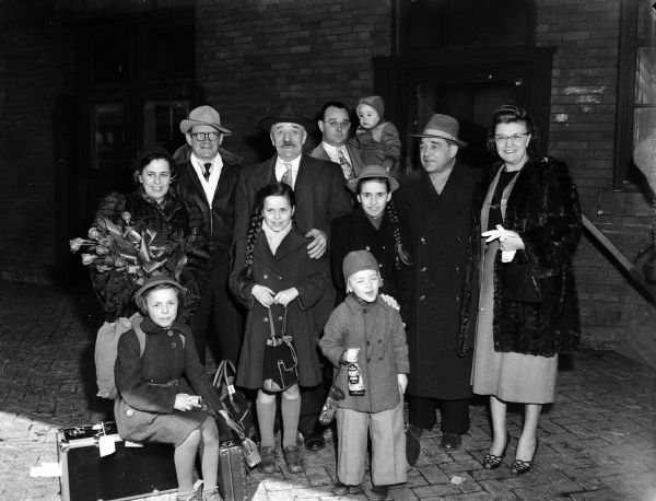 Peter Storch, engineer at Ann Emery hall, and his children are shown at the Milwaukee Road depot where they met their son and brother, Alois Storch with his family. Also present are brother William Storch and sister Mrs. Gertrude Rego.