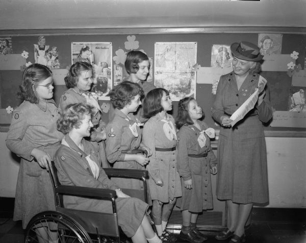 Erna Schweppe showing members of her Troop No. 6 at Washington Orthopedic school a proclamation by Governor Walter Kohler recognizing the 40th anniversary of girl scouting in America.