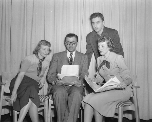 Playing leading roles in "The Concert" play reading by the Pi Eta alumnae chapter of Phi Beta are, left to right: Mrs. W.G. (Mary) Ogden, Jr., Ray J. Stanley, Rex Rucker, and Mrs. Robert (Lois) Dick. The national fraternity for speech and music performs the play reading to benefit their scholarship fund at the University of Wisconsin.