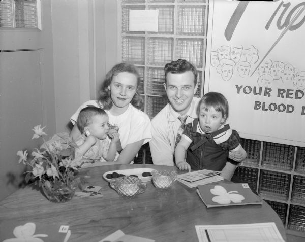 Mr. and Mrs. Harold Wilson, blood donors, and children, Mike, left and Sharon, right, at the Red Cross blood bank.
