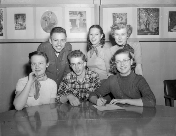 Group portrait of Madison high school representatives working on a youth radio show.  Seated, left to right:  Maggie Goldsmith, Edgewood; Alan Freas, West; and Mary Kate Lorenz, Wisconsin High. Standing: Paul Ives, Wisconsin High; Joan Taliaferro and Donna Heggestad, Central.