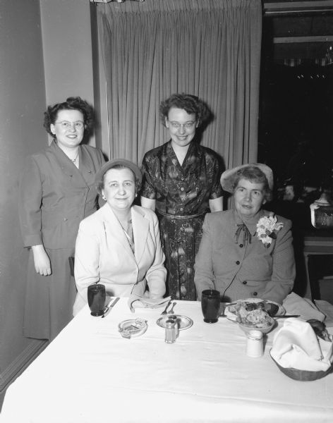 Miss Ruth Coe (seated on the right), who is president of the Wisconsin State Nursing Association, was the guest speaker of Madison Private Nurse section dinner. Local officers are chairman Mrs. Genevieve Fauerbach who is seated on the left, and standing are Miss Helen Drehlow, secretary, on the left and Mrs. Eunice Premo, first vice-chairman.