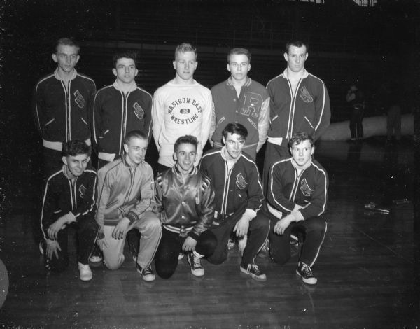 Group portrait of the Milwaukee South Division High School wrestling team, winners of the WIAA State Wrestling Tournament. Team members include Len Krzykowski, Richard Dent, Carl Kopps, Dick Zur, Don Barkowiak and Bob Sobczak.
