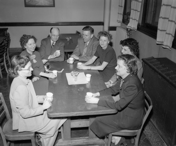 Madison teachers taking a break from first aid training by the Red Cross for the civil defense program. Around the table at East high school are Edith Olson, Esther Steinde, Lewis Wilkins, Harold Foote, Dorothy Puestow, Nancy Vanimen, and Eleanor Rhinehart.