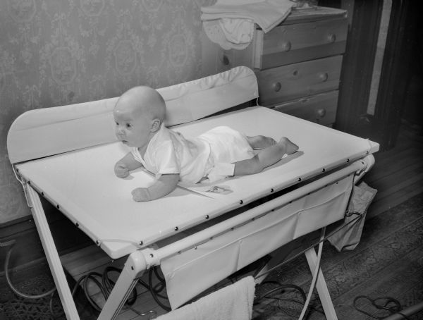 A two-month old infant boy on a bassinet. The sounds of his birth were  recorded to be used in a program "Birth of a Baby". The program would be broadcast on a local radio program on station WISC and later on a national network. It was the first such event in radio history.