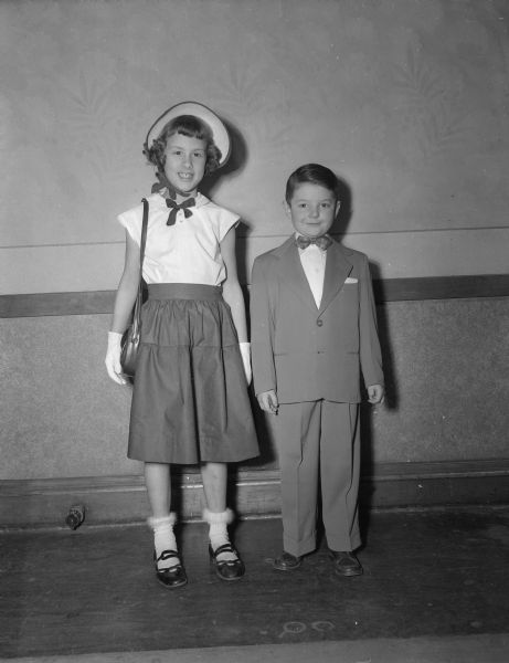 Jean Staack, at left, and Dennis Galarowicz, at right, model clothes to be featured in the St. Raphael's school style show. Among the other models are additional boys and girls who are students at St. Raphael's, and a few of the school's PTA mothers.