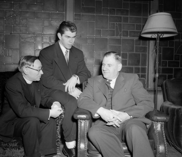 George O'Brien, captain-elect of the 1952 University of Wisconsin football team stands between the Reverend Alvin Kutchera and Coach Earl Wilke of Edgewood before he was honored at the "Athletic Night" dinner in Newman Hall of St. Paul's student chapel.O'Brien was named to Extension magazine;s All-American All-Catholic football team.