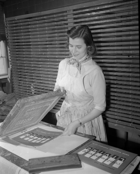 Mrs. Frank (Eldora) Gulcynski making the cover for the year book for the Wisconsin Dames organization.
