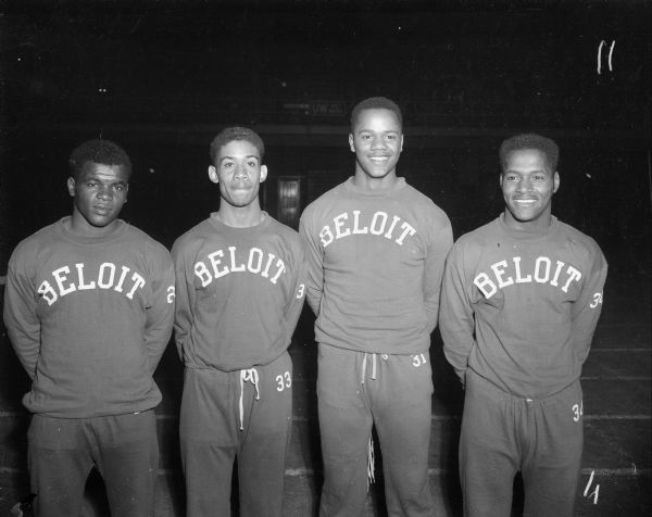 Group portrait of Beloit high school 880 yard relay team. They won their event by 3/10s of a second. Their time was 1:35.1, 8/10s off the record. They are, left to right, George Foster, LaVerne Bradford, Frank Clarke and Tarzan Honor. All four are African-American.