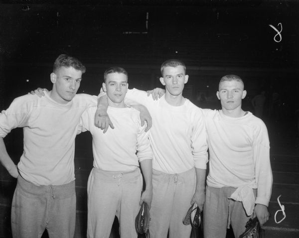 Group portrait of four Richland Center high school boys who won the 880 yard relay race which helped their team win the Class B team title at the Madison West High School Track Relays at the University of Wisconsin-Madison Field House. From left to right are Bruce Boegel, Ronald Lewis, Bill Ewing and Wilbert Hanson.