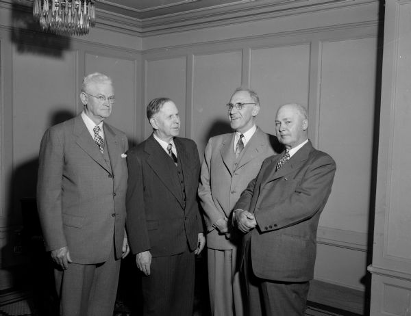 Oliver S. Rundell, retiring Dean of the UW Law School, was honored at a banquet at the Hotel Loraine. Left to right are Attorney J.D. Darrow, Argyle; Dean Rundell; Brown county Judge Archie McComb, Green Bay; and Oscar Rademacher, Medford attorney.
