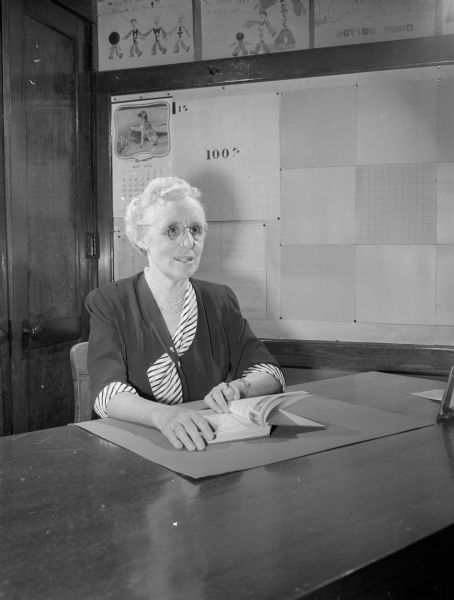 Helen Gardner, a Madison Vocational and Adult Education teacher, seated at a classroom desk.