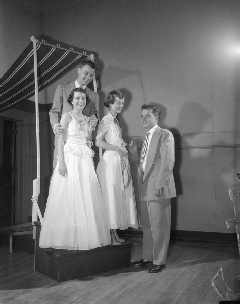 Two couples, in formal dress, are posed by a canopy. They are Marilyn Libert and Jim Bergenske (left), and Pat Mulrooney with Bill O'Brien (right).