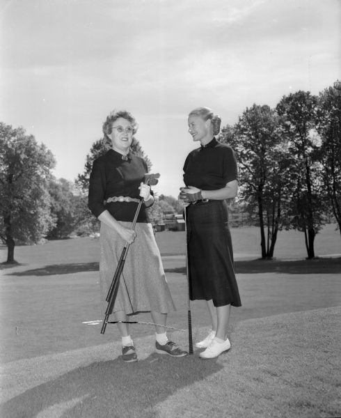 Posing with their golf clubs are, left,  Dorthy Snodgrass, assistant tournament and special events chairman; and right, Virginia Sprague, representative on the Women's Western Golf Board.