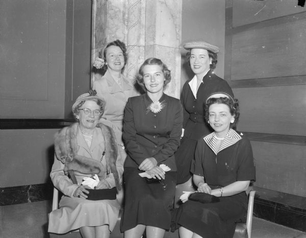 Family members of the Alpha Chi Omaga sorority at the state luncheon at the Memorial Union. Chosen as the guest of honor is Mrs. M.O. (Iola) Withey (seated at left), wife of the dean of the college of engineering at the University of Wisconsin. Seated on the right is her daughter-in-law, Mrs. Norman (Marion) Withey. Her two daughters, standing in the back are Mrs. W.W. (Marion) Engelke, left, and Mrs. Hugh F. (Elizabeth) Oldenburg, right. In the center is a granddaughter, Eleanor Jean Withey. All of the women are members of the sorority.