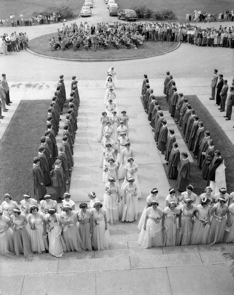 May crowning of the Blessed Virgin Mary at Edgewood College, Madison. Part of the court of honor is shown with Rosemary Darcey, Watertown, (last in the center row) who was selected by the school to crown the Blessed Virgin in the centuries-old ceremony which traditionally takes place in the month of May.