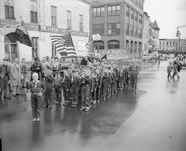 Cub Scout Pack 329 from Emerson School lines up on Doty Street for the Memorial Day parade around Madison's Capitol Square. Monona Tire Company on the corner of Doty and Pinkney streets is in the background, as well as the Cantwell Building at 121 South Pinkney.