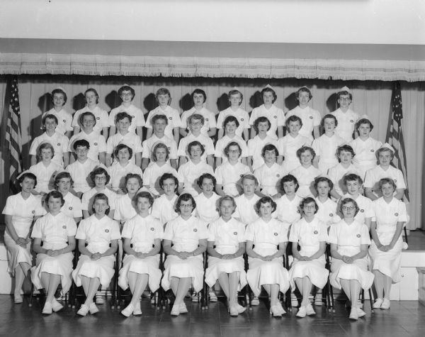 Group portrait of 48 Madison General Hospital student nurses on the event of their 'capping ceremony' which marks the end of their first year of training.  Members of the class graduated in September, 1954.