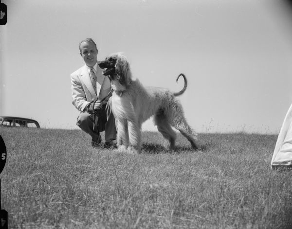 Daniel Oakley, shown with his Afghan hound, "Slug". The dog will be competing at the Badger Kennel Club dog show.