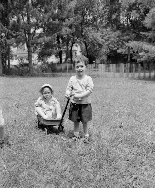 Billy Beuscher, right, pulling Charles Schlatter in a wagon at the Shorewood Hills Play School, a summer recreation program at Shorewood Hills parks and schools.