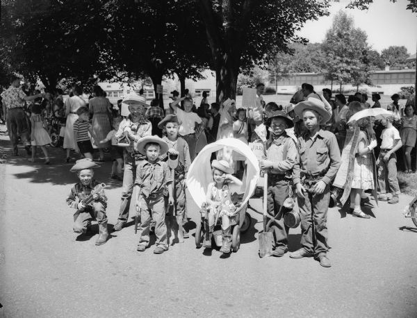 Seven children dressed as cowboys 'portray the hardship of the 49ers trail.' They are, left to right: Bobby Curtis, John Curtis, John Levy, Bruce Levy, Virginia Burley, Bobby Braun and John Burley.