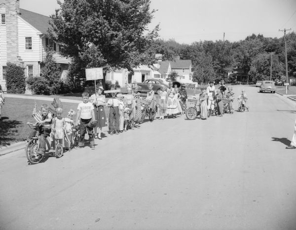 A lineup of over twenty costumed children assembled along 2620 Chamberlain Street in the Shepard Terrace neighborhood. They had performed a circus for Roundy's Fun Fund and raised $12.25.