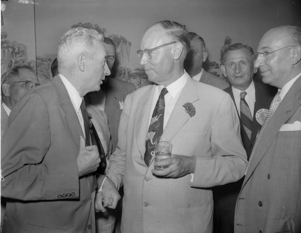 Senator Robert A. Taft, right, confers with his convention floor manager Thomas Coleman of Madison and a group of supporters after Wisconsin Republican delegates favoring the Ohio senator for the GOP presidential nomination held their caucus in Chicago's Bismark Hotel, the delegation's headquarters.