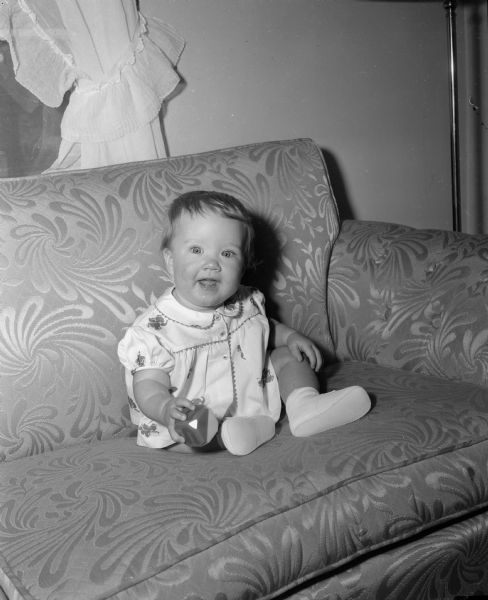 Anne Muckler, the eight-month-old daughter of Mr. and Mrs. Carl Muckler of 4206 Drexel Avenue, is shown wearing a diaper and blouse set decorated with elephants. The outfit is also available with a pattern showing donkeys. Parents can display their political sentiments by which animal is on the child's clothes.