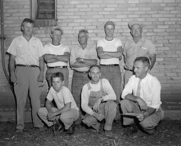 Group portrait of the Madison park commission crew, responsible for the construction of the starting ramp and finish line platform for the Madison Soap Box Derby. Front row, kneeling left to right: Dee Culp, Ed Culp, and James Marshall, park commissioner. Back row, standing left to right: Myron Cramer, Dan Finn, Bill Merz, Vic Cramer, and Herb Gorman.