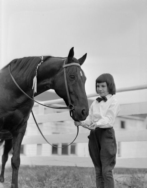 Nine-year-old Bonnie Timmons with Maurice Klinke's horse, Ebony. She is entered in the junior horsemanship class in the Madison Saddle Club horse show.