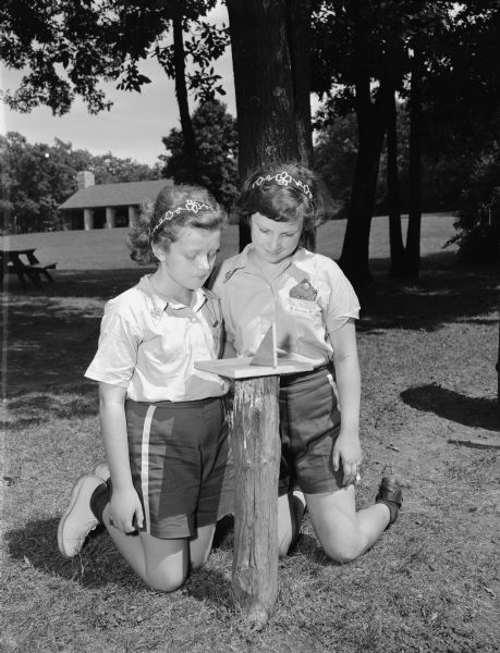 Campers Marilyn Homes, left, and Patricia Brown, right, learn to read a sundial at the Brownie Hoyt Park Day Camp.