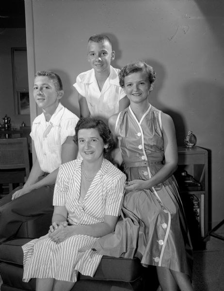 Group portrait of Mrs. Russell (Etta) Pleune and her three children, Ann (left), Peter (standing), and John. Dr. Russell Pleune is the new chief of professional services at the new Veterans' Administration Hospital. The family, who were formerly residents of Temple, Texas, are living at the VA hospital quarters.