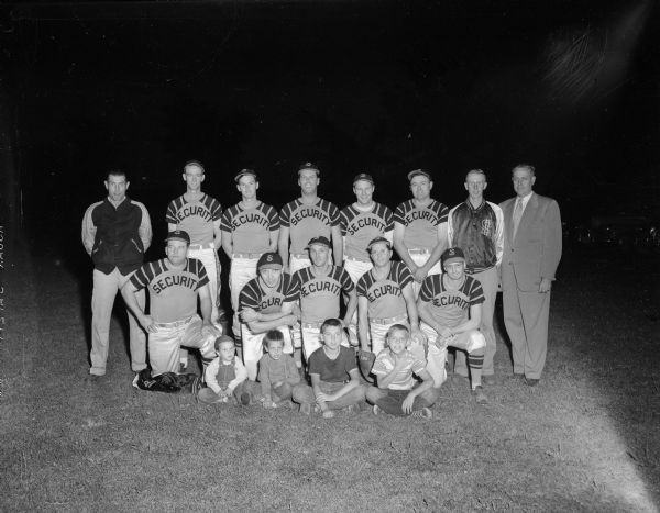 Group portrait of the Security State Bank Softball team which was bidding for its second straight championship in the Major tournament of softball in Madison.  Bob Goodman is shown, fourth from left, in the back row.
