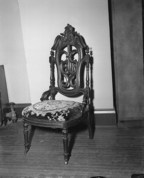 An ornate chair from the antique collection of the late Miss Catherine Corscot.