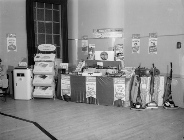 A display of Westinghouse vacuum cleaners with a sign "Pick the Winner."