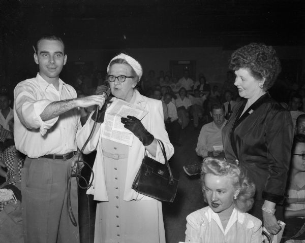 Mrs. R.R. (Helen) Brinsmade of Madison, right, takes a microphone to defend the record of U.S. Senator Joseph B. McCarthy during the 25-hour radio talkathon of Leonard F. Schmitt, Merrill attorney who is challenging McCarthy for the Republican nomination in the primary.