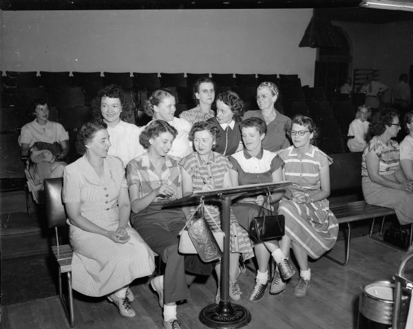 Group portrait of ten bowlers from the Lucky Strikers and the Fearless Five teams in the Industrial Commission Girls loop of the woman's bowling league at the Plaza Alleys.