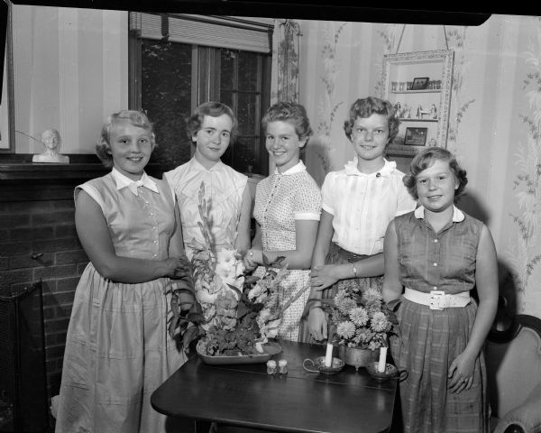 Group portrait of some of the guests in attendance at a unique "end of summer" party given by Bobbie Lampert, daughter of Mr. and Mrs. Harold M. (Beatrice) Lampert, at the family home at 1907 Rowley Avenue. Pictured left to right: Marcia Winn, Mary Howdle, Bobbie Lampert, Mary Hess, and Barbara Hursh.
