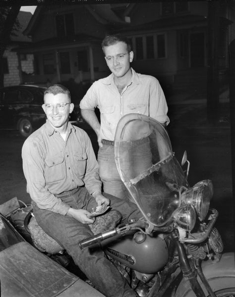 Bill Mickle, left, and Edwin Smythe posing with the motorcycle on which they traveled to Fairbanks, Alaska on a recently completed 12,000 mile summer vacation trip.