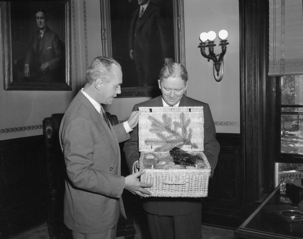 Wisconsin Governor Walter Kohler presenting a cheese basket to visiting Florida governor Fuller Warren.