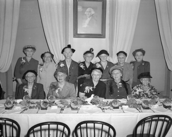Group portrait of the guests of honor at the annual fall luncheon of the Chicago and Northwestern Railroad Woman's Club. The guests of honor were eleven charter members who joined the club when it was organized in 1921.