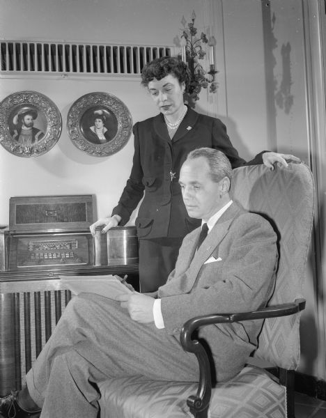 Governor Walter J. Kohler, Jr. and Charlotte Kohler, listening to the radio, kept a close tabulation of state and national election returns Tuesday night at the executive residence. Kohler handily defeated his Democratic opponent, William Proxmire, for a second term as governor.