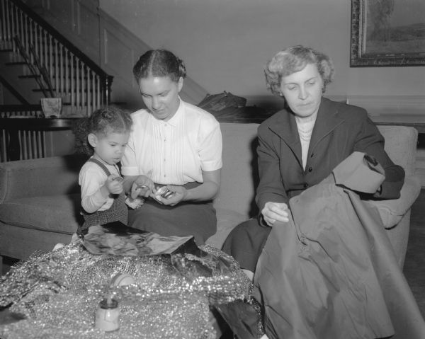 Audrey Lewis (center), health education director at the City YWCA, her daughter, Jeri, and general chairman Marian Brandenburg preparing decorations for the 'Hanging of the Greens' for the YWCA.