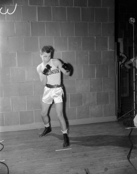 Portrait of William Judson of Chicago, 139 pounds, one of the Judson twins on the University of Wisconsin boxing team.
Included in the set of negatives are portraits of 9 other identified boxers: Everett Chambers, Bobby Lees, Truman Sturdevant, Sam Carlino, Charlie Schied, Gordon Ledford, Bobby Goodsitt, Robert Morgan and Robert Judson, and 11 negatives of unidentified boxers.